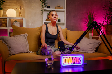 Caucasian bald woman radio host recording podcast in a cozy studio