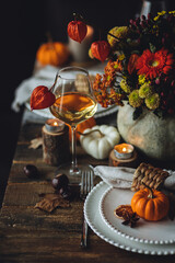 Fall table decoration with pumpkins, wine. Family cozy thanksgiving dinner arrangement indoors at home, wedding elegant decor. Countryside style, simple handmade setting, autumn mood, inspiration.