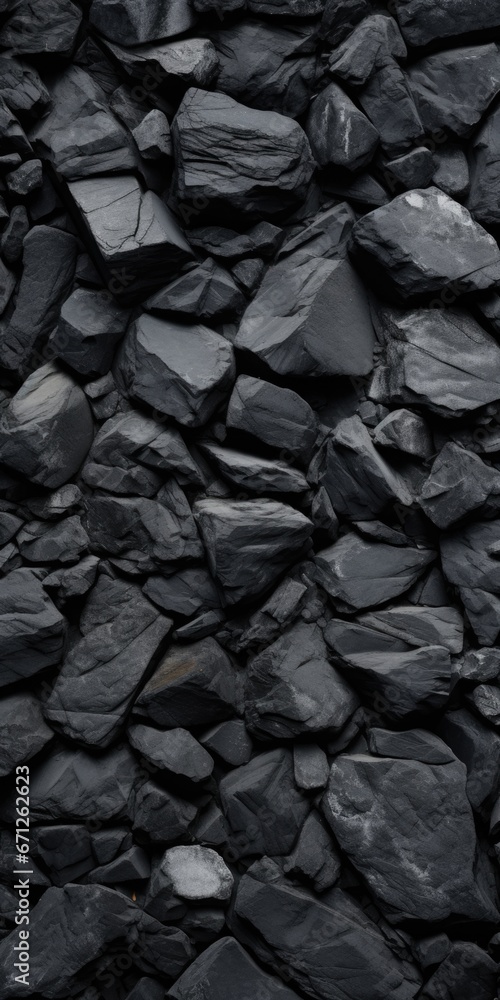 Poster a pile of black rocks is displayed in this image. this versatile picture can be used to depict natur