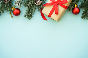 Christmas Present and red decorations at color background. Flat lay image with copy space.