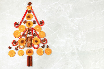 Christmas background in the form of an edible Christmas tree with winter traditional spices to...