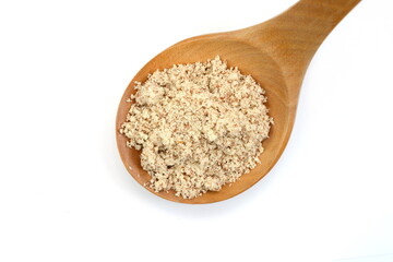 Shelled and ground Ground, milled, crushed almond nuts in a  wooden spoon isolated on white....