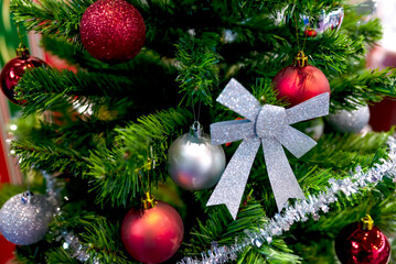 Decorated and green Christmas Tree Closeup with shiny ornaments.