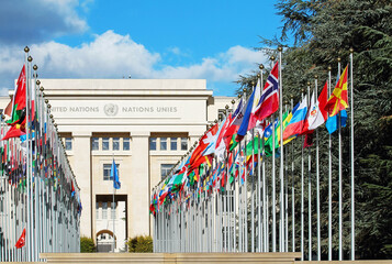 Flags in front United Nations Palais in Geneva Switzerland. - obrazy, fototapety, plakaty