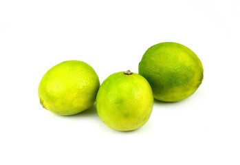 three whole limes on a white isolated background