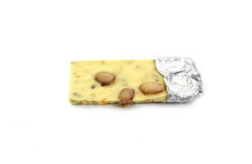White chocolate bar with pistachios and almonds isolated on white background.