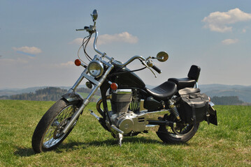 Vintage chopper motorcycle roadtrip in summer day. Custom style. Leather bags.