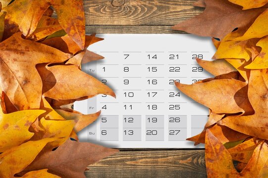Autumn background with calendar and leaves.