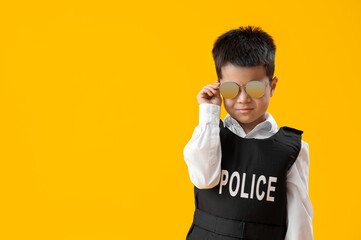 Cute little policeman on yellow background