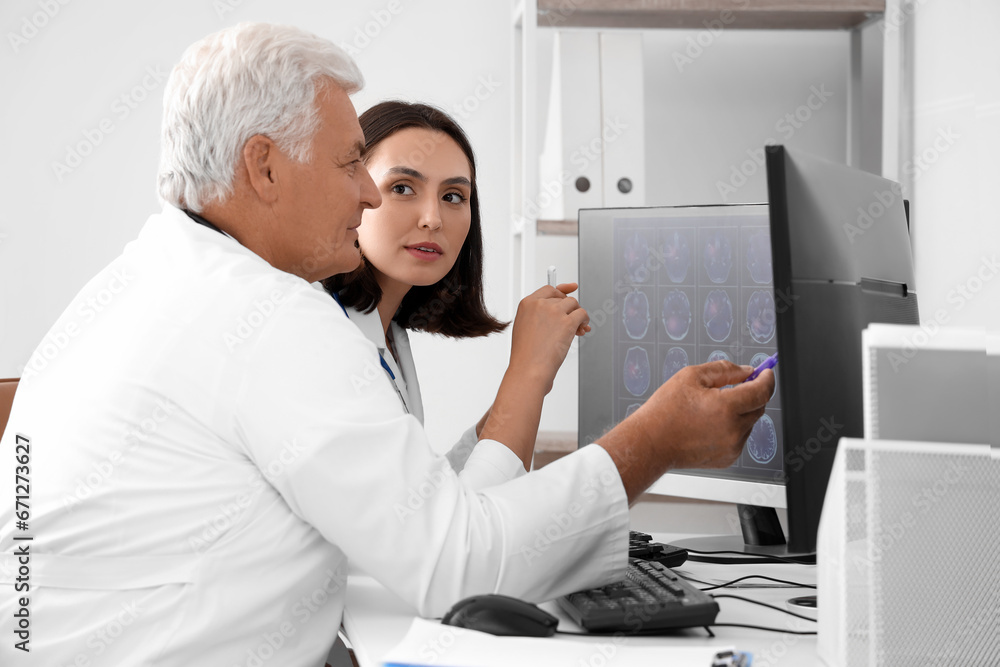 Sticker Doctors discussing x-ray image on computer in medical office