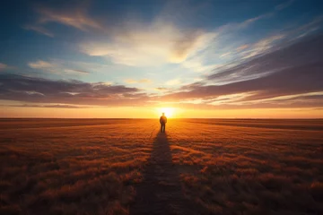 Foto op Plexiglas A solitary traveler fading into the twilight of the field, embracing the sunset, like a hero of boundless expanses © Konstiantyn Zapylaie