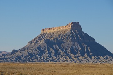 The landscape in Southern Utah is one of the most unique and otherworldly scenes in the United States. Pictured here is the Factory Butte, a notable landform in the area.