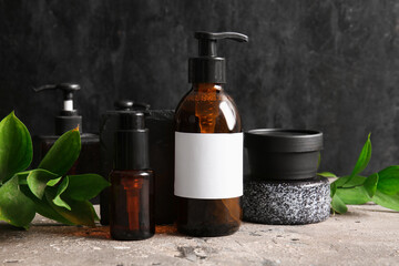 Bottles of shampoo and cosmetic products on table