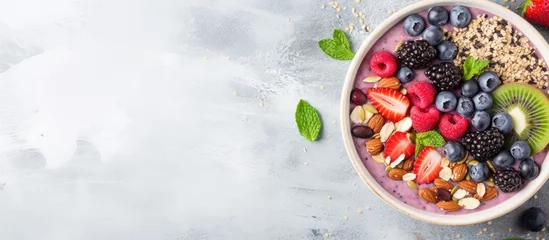 Fotobehang A nutritious breakfast option for vegans and vegetarians is a smoothie bowl topped with a medley of fresh berries nuts seeds and a homemade granola © 2rogan