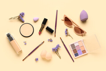 Composition with makeup products, beautiful gypsophila flowers and sunglasses on beige background