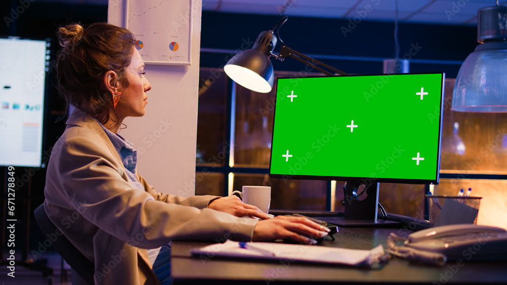 Poster business manager using pc with green screen at desk, working on financial investment with chroma key