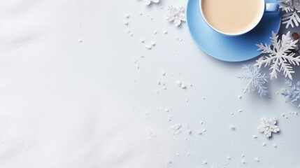 Cozy winter beverage in a blue mug surrounded by snowy ornaments, silver snowflakes, and a sparkling atmosphere on a pastel blue background.