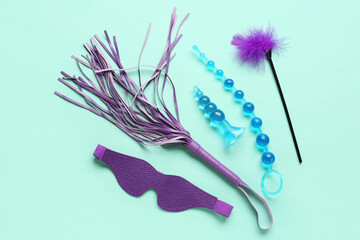 Different sex toys on turquoise background
