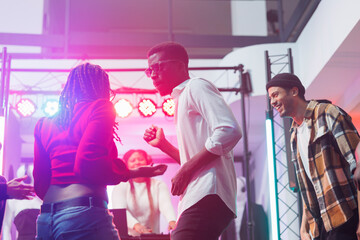 African american dancers couple improvising moves at live electronic music discotheque in...