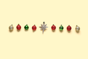 Composition with different Christmas balls and star on beige background