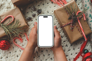 Phone with isolated screen on background of Christmas gifts