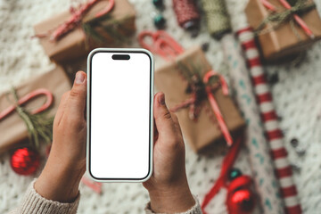 Phone with isolated screen on background of Christmas gifts