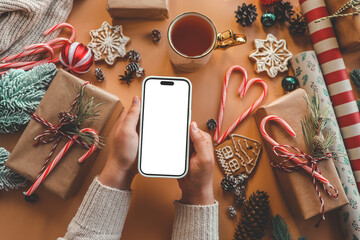 Phone with isolated screen on background of Christmas gifts