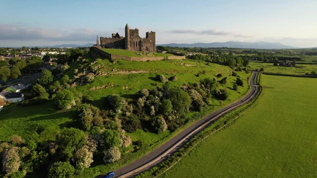 IRELAND- 8.27.2023 -Excellent aerial footage approaching Ireland's Rock of Cashel as a car drives by.
