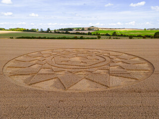 Fototapeta na wymiar Aerial view of an intricate geometric crop circle formation in a wheat field in Wiltshire, England, UK
