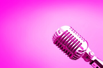 Fototapeta na wymiar Retro pink microphone on abstract background