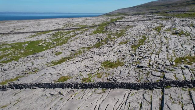 IRELAND- 8.27.2023 -Excellent aerial footage panning The Burren in Ireland, headed for the water.