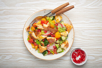Traditional Levant dish Fattoush salad, Arab cuisine, with pita bread croutons, vegetables, herbs....