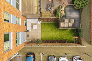 Aerial view of building and backyard with parking lot
