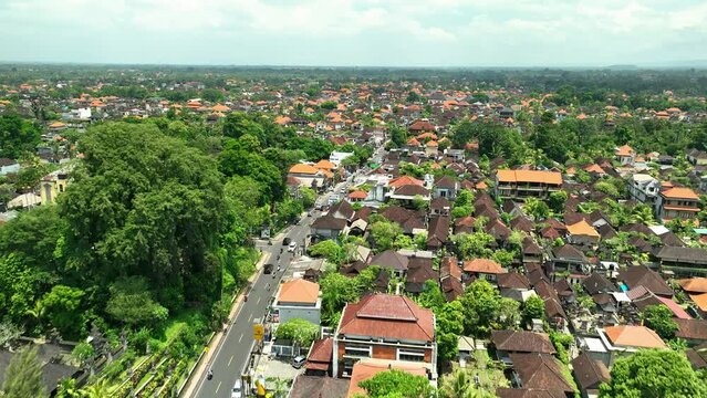 2023 - Excellent aerial footage of cars driving into a residential area of ubi.