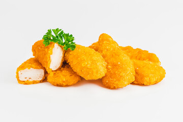 Breaded Chicken Inner Fillet on a White Background,Chicken Breaded Raw Meat.Chicken Breaded Fillet.Fast food. Fast cooking. Breaded chicken nuggets. Homemade food at home.