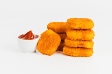 Breaded Chicken Inner Fillet on a White Background,Chicken Breaded Raw Meat.Chicken Breaded Fillet.Fast food. Fast cooking. Breaded chicken nuggets. Homemade food at home.