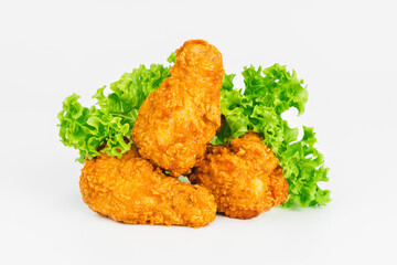 Semi-finished product, fried wings.Breaded Chicken wings with salad on a White Background,food at home.Fast homemade food.Chicken Breaded Raw Meat. Fast cooking.