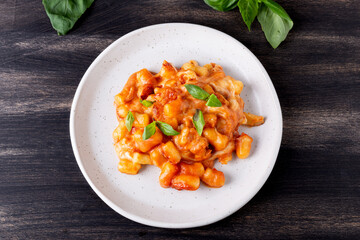 Gnocchi with tomato sauce, mozzarella cheese and basil. Italian traditional food.