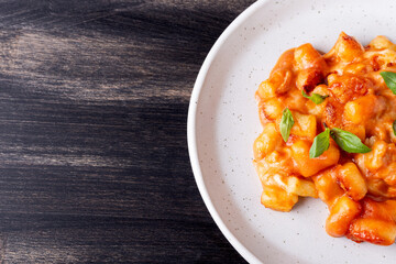Gnocchi with tomato sauce, mozzarella cheese and basil. Italian traditional food.