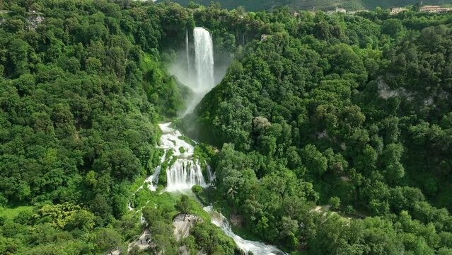 ITALY - AUGUST.9.2023 - Excellent aerial footage of Marmore Falls on a green mountainside of Umbria, Italy.