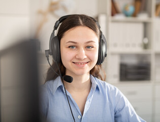 Portrait of a smiling dispatcher girl working in an office. Close-up portrait