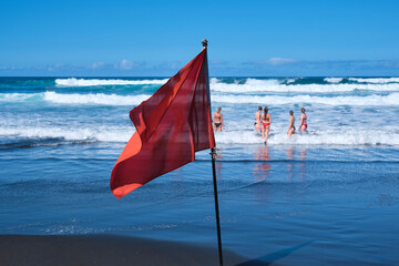 Red Flag Sign at the Beach, Signifying No Swimming Due to Strong Waves