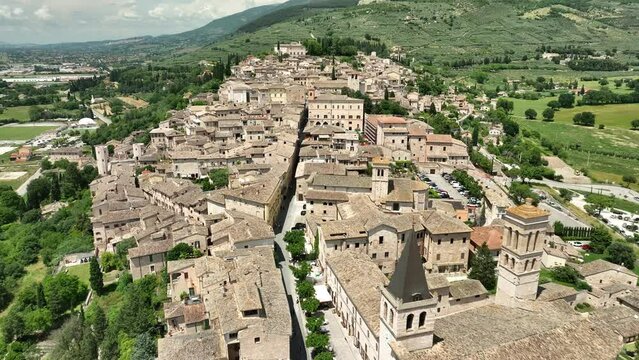 ITALY - AUGUST.9.2023 - Excellent aerial footage moving over the rooftops of the green mountaintop city of Umbria, Italy.