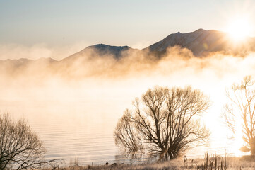 Morning mist on the mountain lake in New Zealand