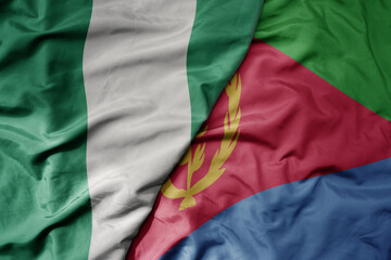 big waving national colorful flag of nigeria and national flag of eritrea .