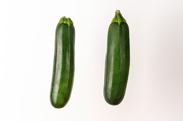 couple of zucchini vertically isolated on white background - obrazy, fototapety, plakaty