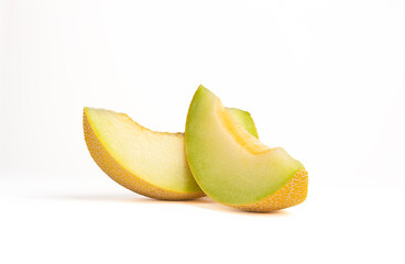 Two slices of yellow melon on a white background