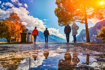 People admiring Lake Garda in autumn time,Garda lake surrounded by mountains, Trentino Alto Adige...