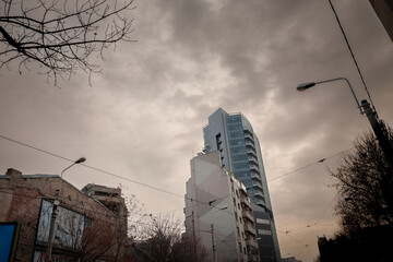 Panorama of the Bucharest Skyline at dusk, in Romania, with a modern office building, a skyscraper,...