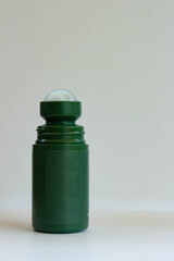 mini green bottle deodorant isolated white